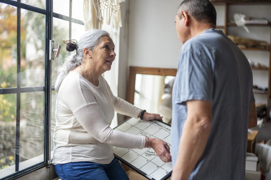 Couple planning their retirement finances in the year before finishing work